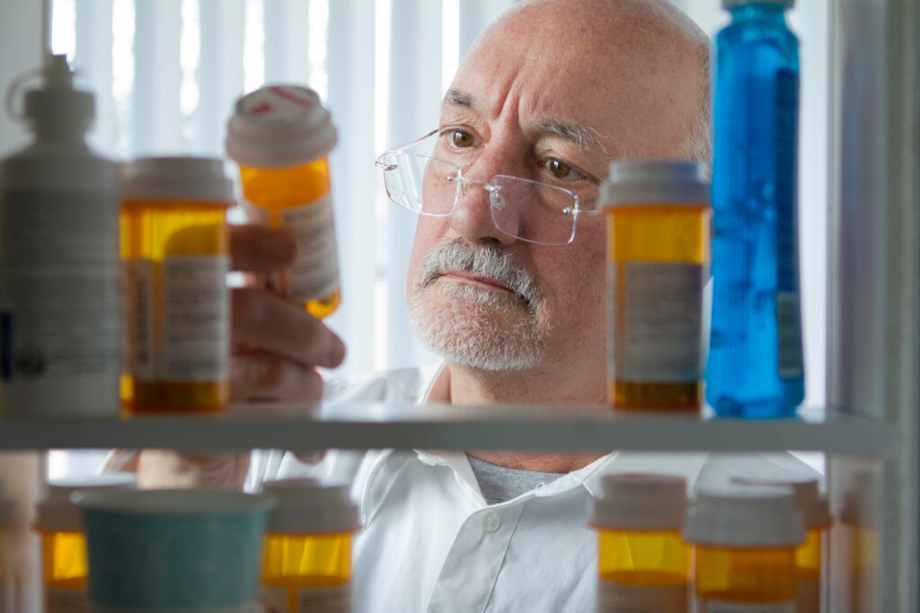Man looking at prescription medication